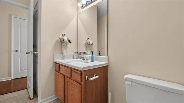 a bathroom with a sink a toilet and a mirror