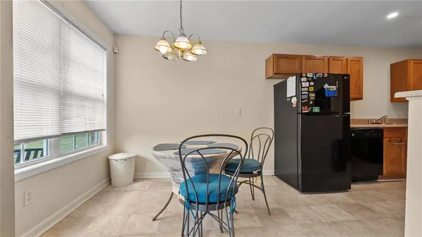 a view of a dining room with furniture and chandelier