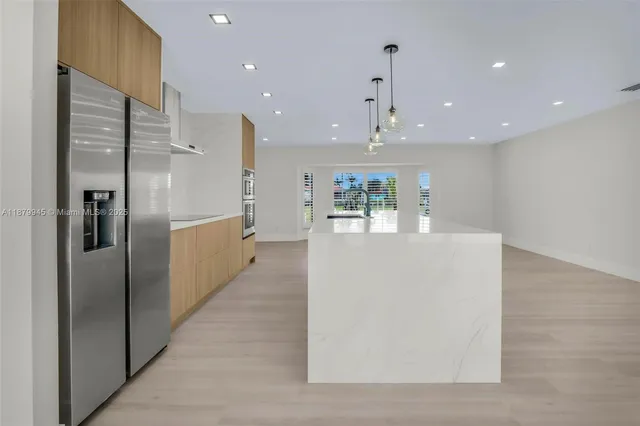 an empty room with wooden floor and window