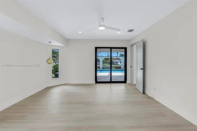 a view of a patio with a table and chairs under an umbrella