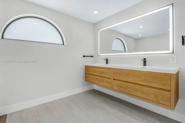a view of a hallway with wooden floor and plants