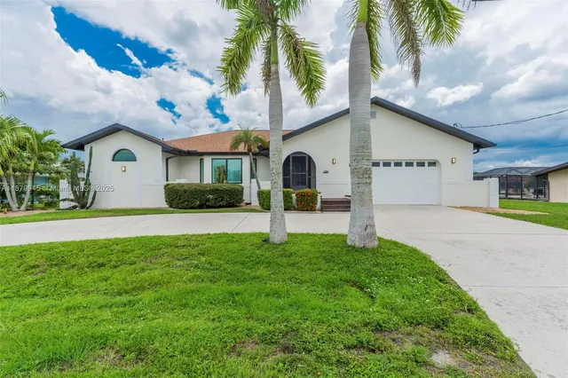 a large kitchen with stainless steel appliances a large counter top and a wooden floors