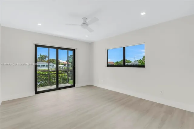 an aerial view of a house with a garden and lake view