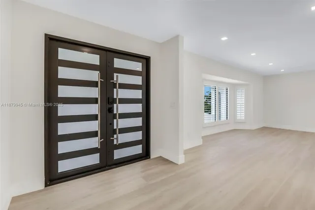 a kitchen with stainless steel appliances kitchen island granite countertop a stove a sink and a refrigerator