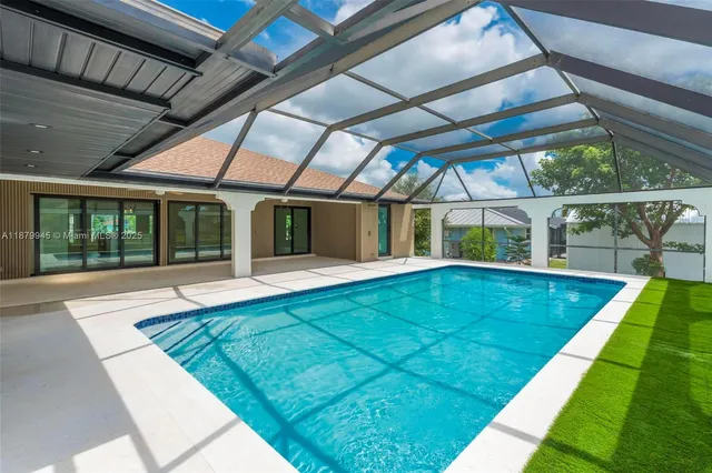 a front view of a house with a garden and tree