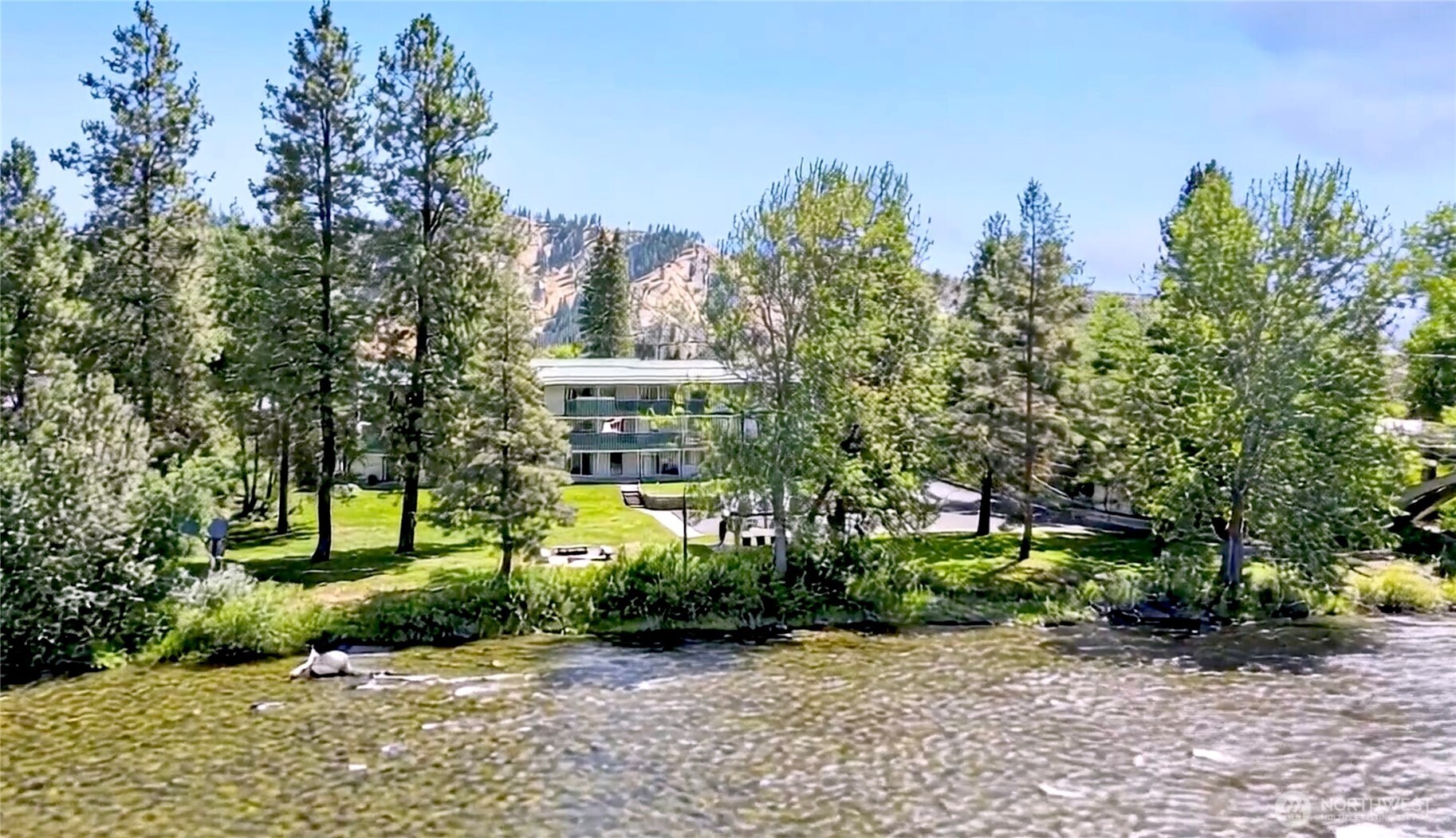 8348 Main Street, Unit 6 Peshastin, WA 98847 - Photo 1 of 34 a front view of a house with a yard and a trees