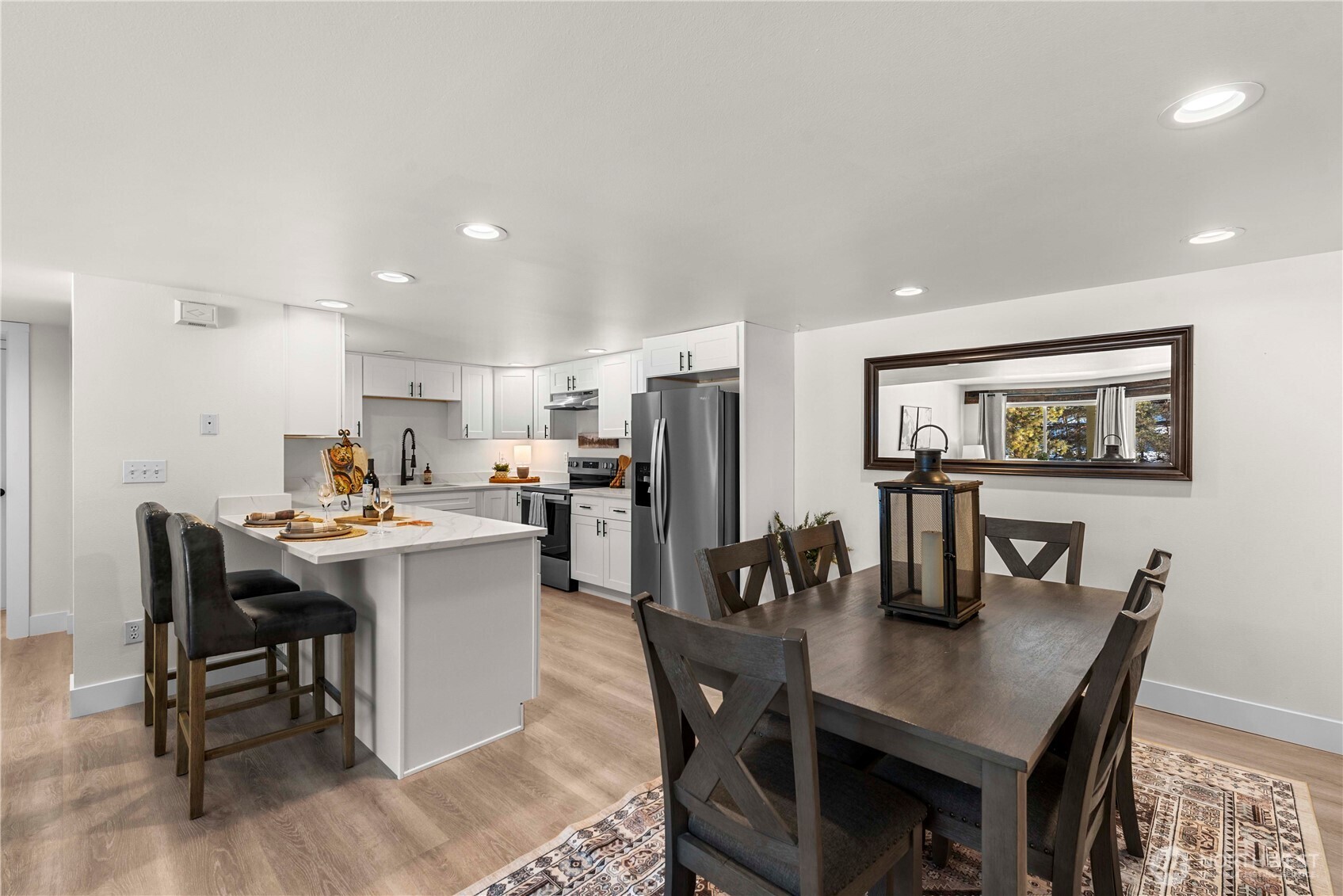 8348 Main Street, Unit 6 Peshastin, WA 98847 - Photo 16 of 34 a kitchen with a dining table chairs and refrigerator
