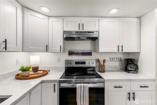 a kitchen with a stove and cabinets