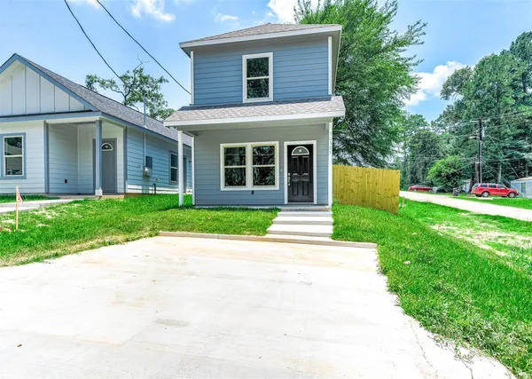 a front view of house with yard and green space