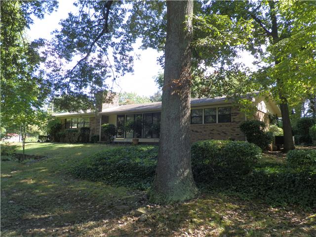 2100 Post Road Clarksville, TN 37043 - Photo 3 of 19 a view of a yard in front of a house with plants and large trees