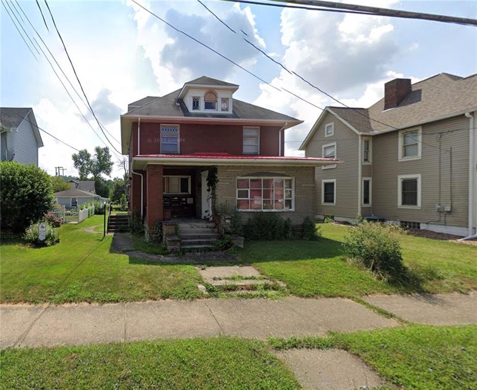 216 East Pike Street Houston, PA 15342 - Photo 1 of 10 a front view of a house with a yard