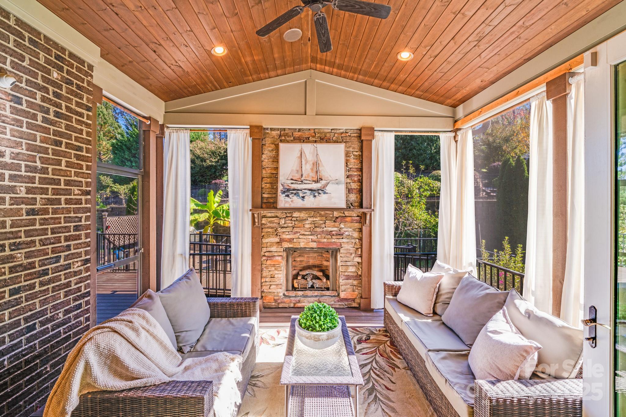 126 Forsythia Lane Tega Cay, SC 29708 - Photo 14 of 32 a living room with furniture a fireplace and a chandelier