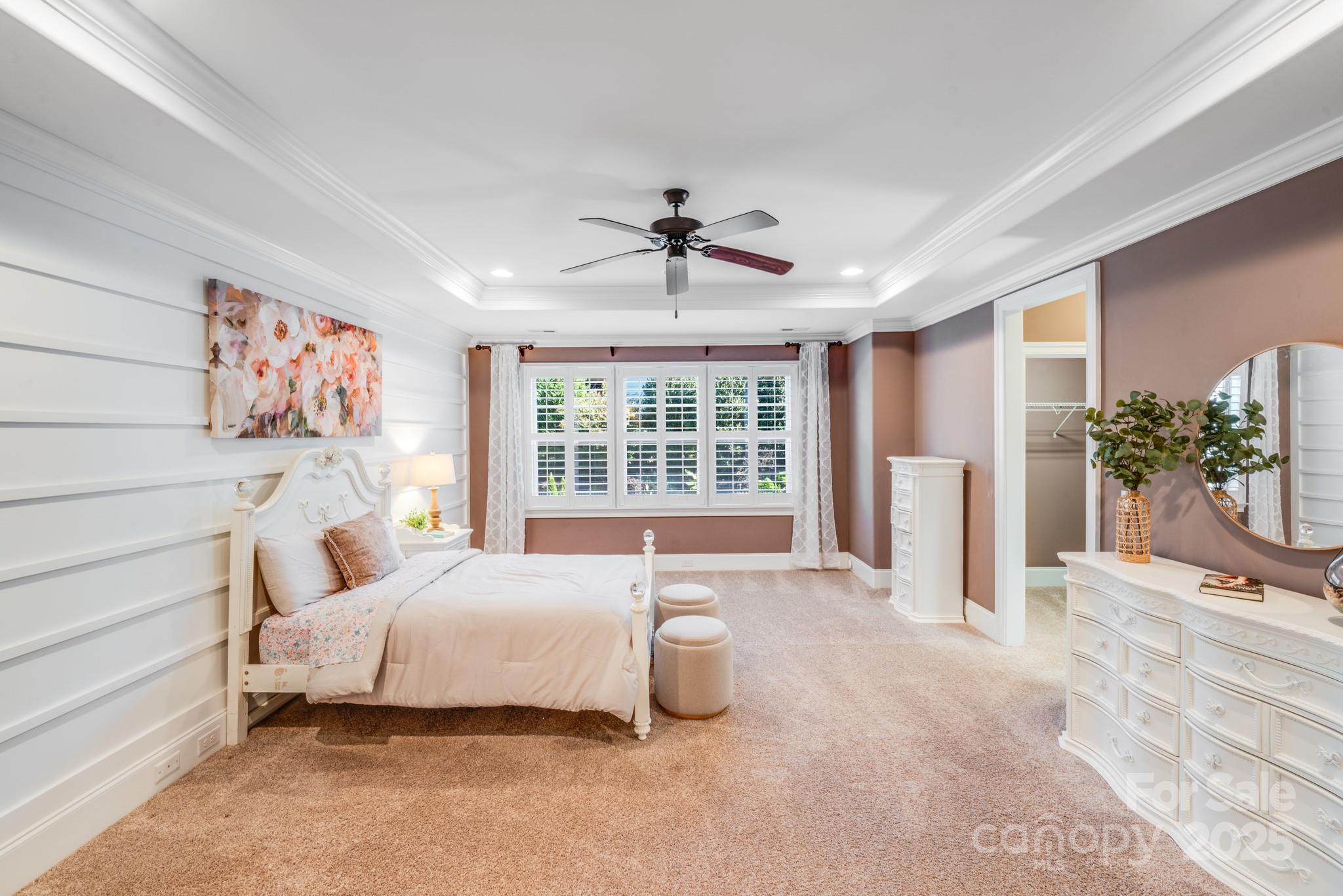 126 Forsythia Lane Tega Cay, SC 29708 - Photo 20 of 32 a bedroom with a bed and a chandelier