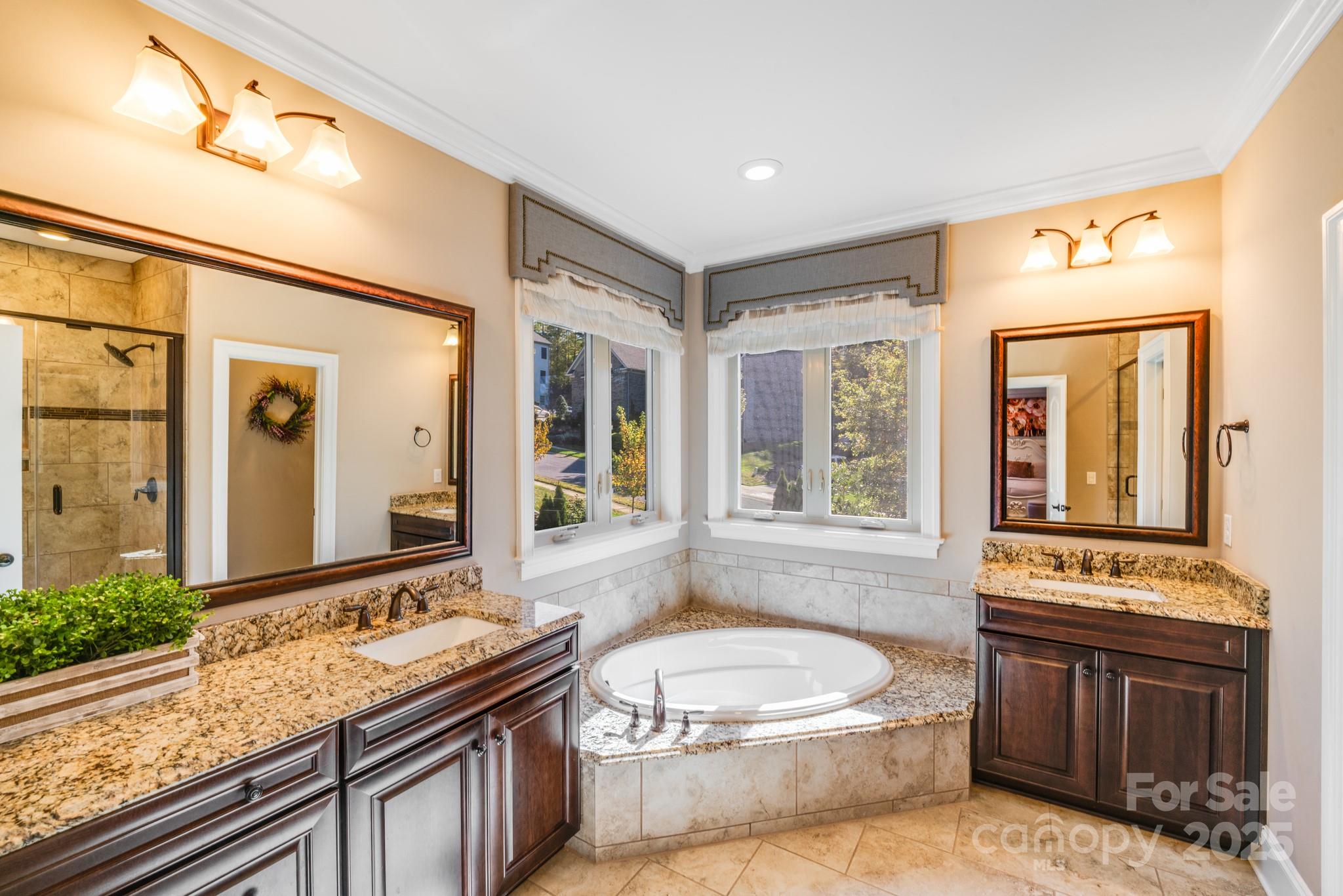 126 Forsythia Lane Tega Cay, SC 29708 - Photo 22 of 32 a bathroom with a granite countertop tub sink and mirror
