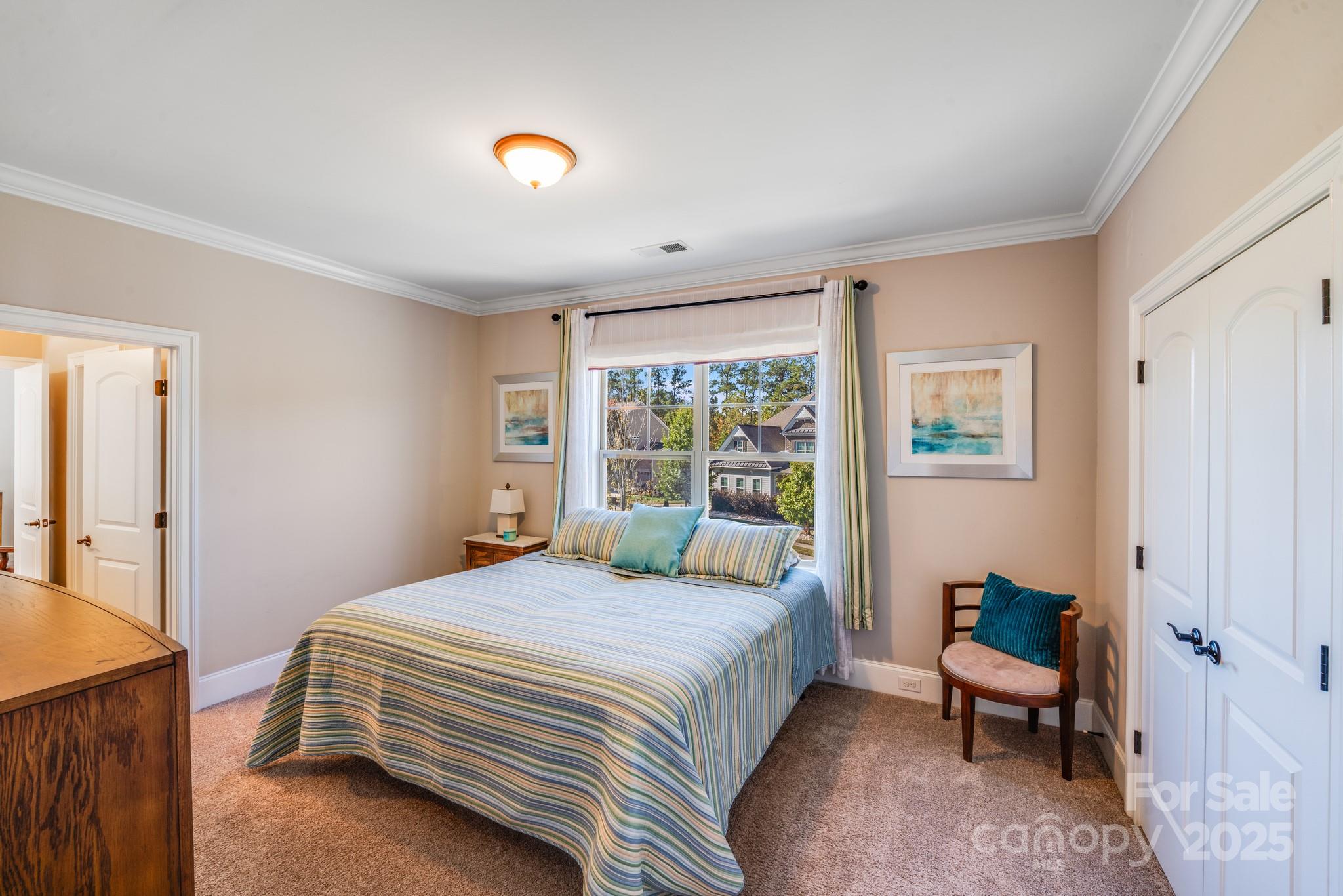 126 Forsythia Lane Tega Cay, SC 29708 - Photo 25 of 32 a bedroom with a bed and a window