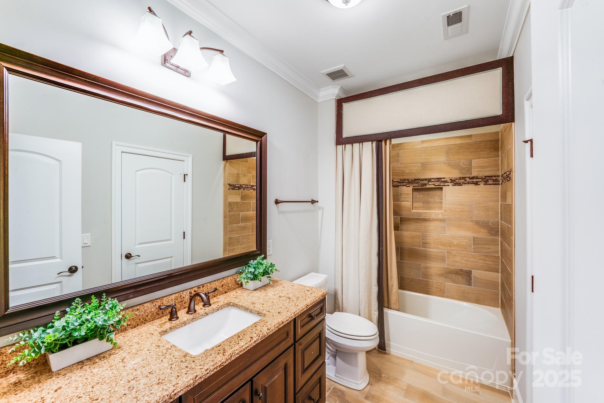 126 Forsythia Lane Tega Cay, SC 29708 - Photo 26 of 32 a bathroom with a granite countertop sink a toilet and shower