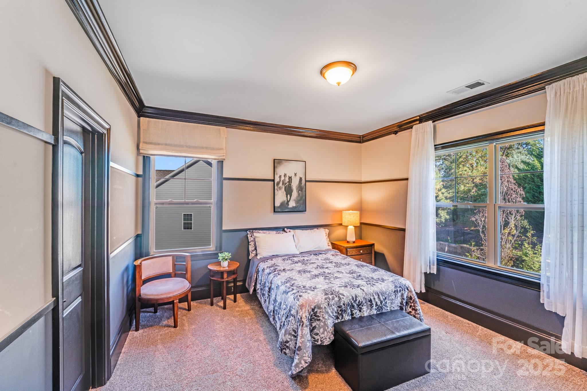 126 Forsythia Lane Tega Cay, SC 29708 - Photo 27 of 32 a bedroom with a bed couch and window