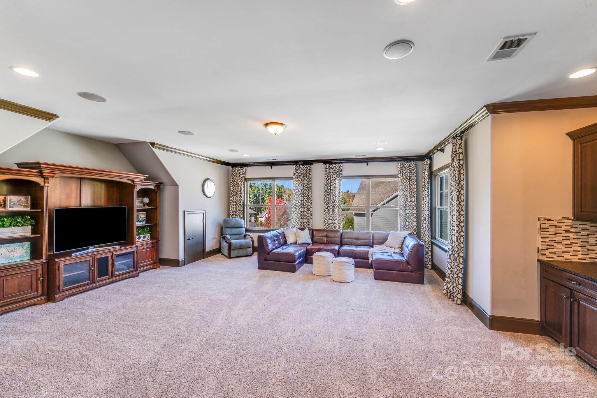 126 Forsythia Lane Tega Cay, SC 29708 - Photo 28 of 32 a living room with furniture and a flat screen tv