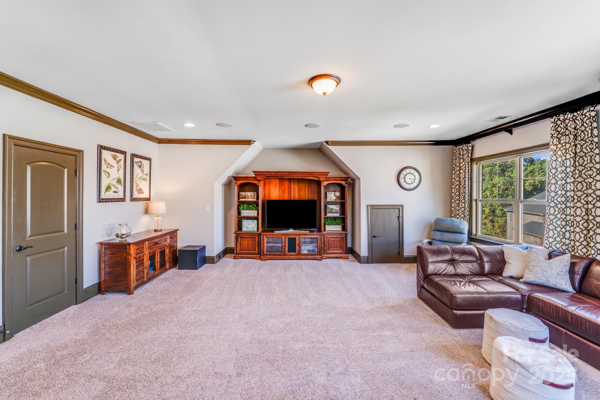 126 Forsythia Lane Tega Cay, SC 29708 - Photo 29 of 32 a view of a livingroom with furniture and a flat screen tv