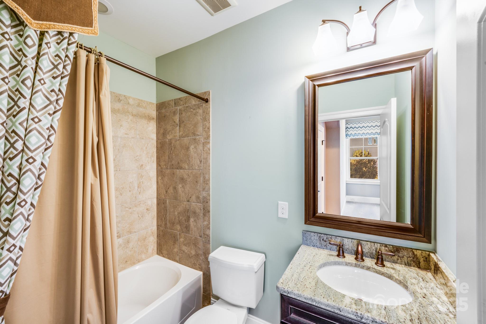 126 Forsythia Lane Tega Cay, SC 29708 - Photo 32 of 32 a bathroom with a granite countertop sink and a mirror