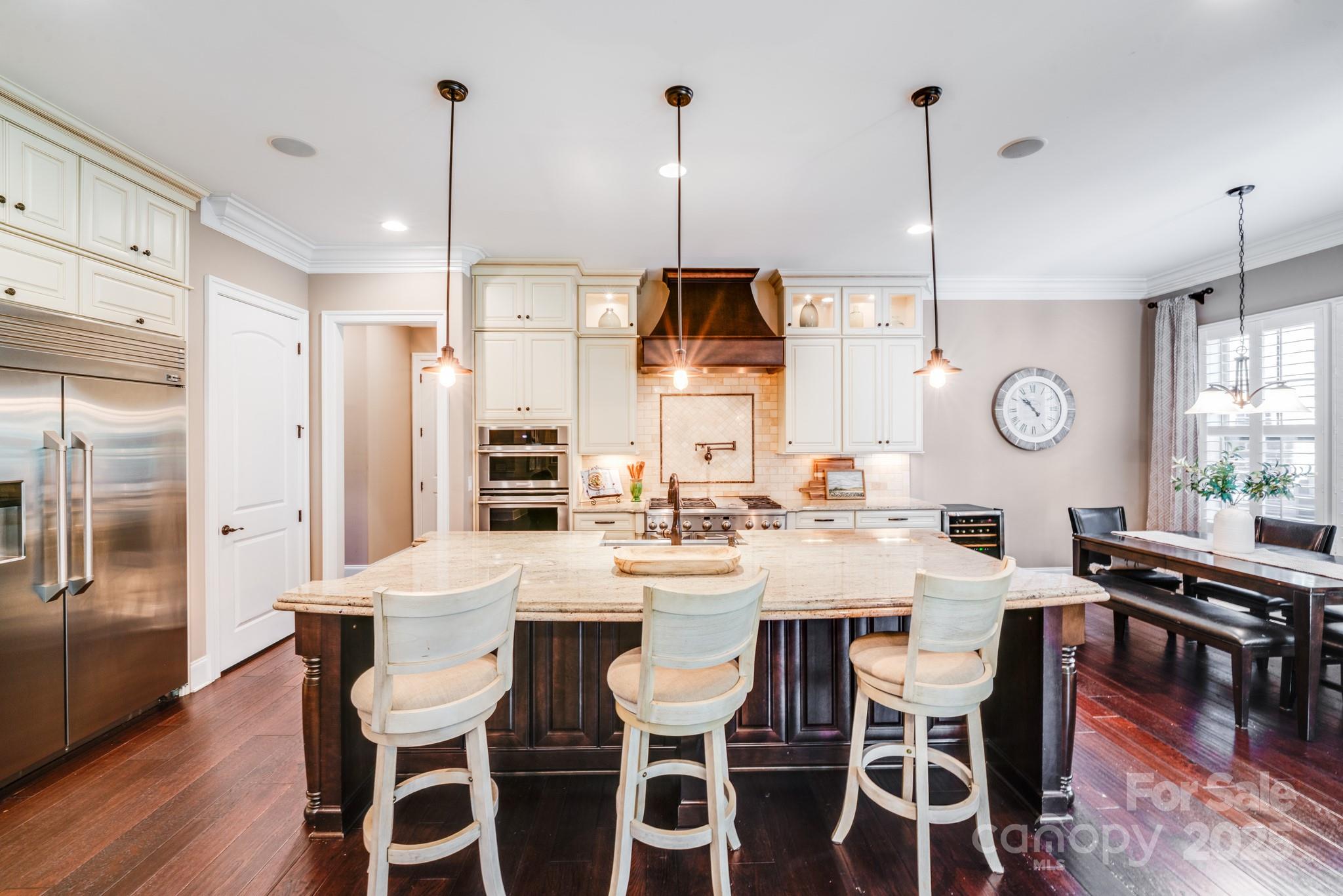 126 Forsythia Lane Tega Cay, SC 29708 - Photo 7 of 32 a dining room with stainless steel appliances kitchen island granite countertop a dining table chairs and couches