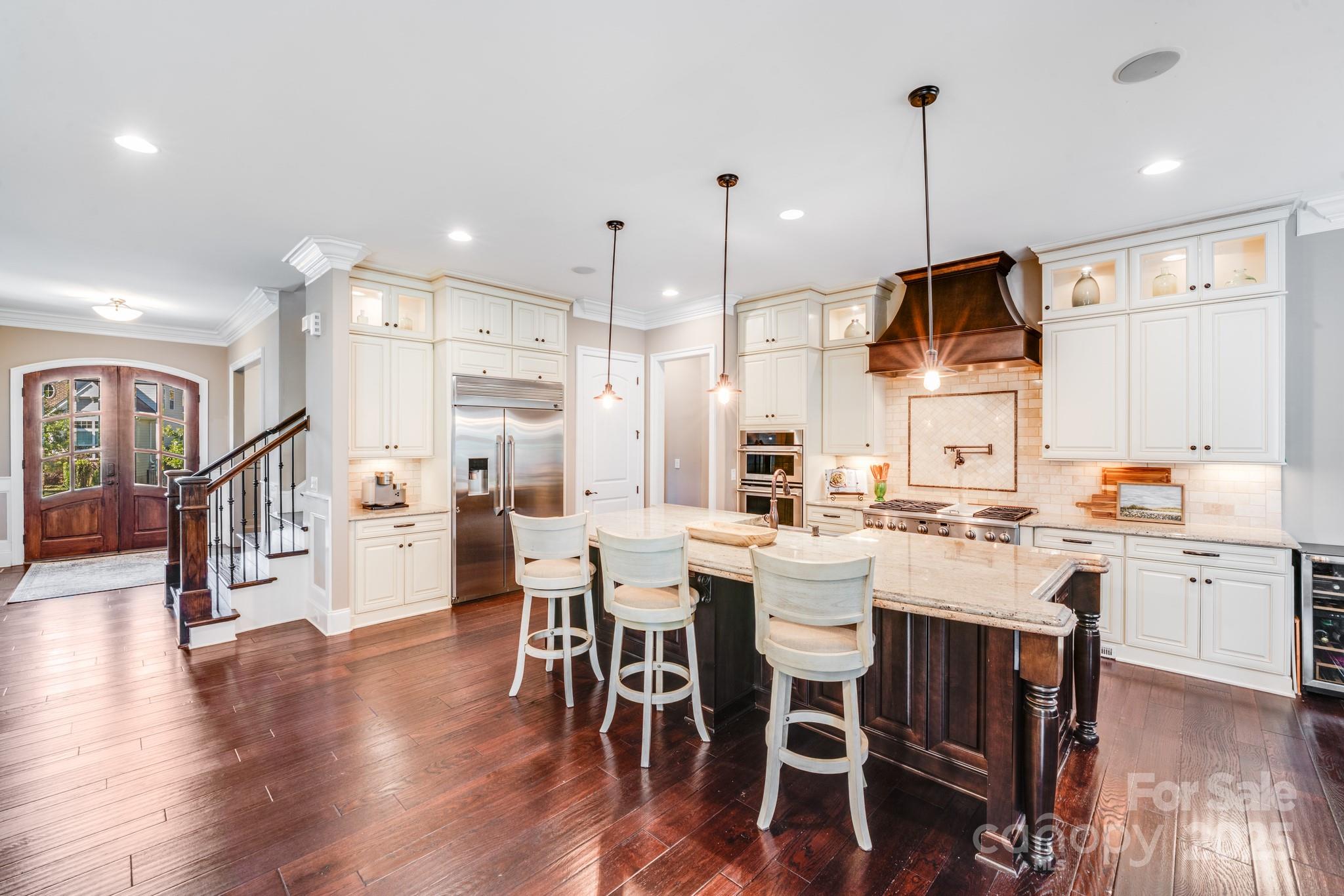 126 Forsythia Lane Tega Cay, SC 29708 - Photo 8 of 32 a large kitchen with a table and chairs