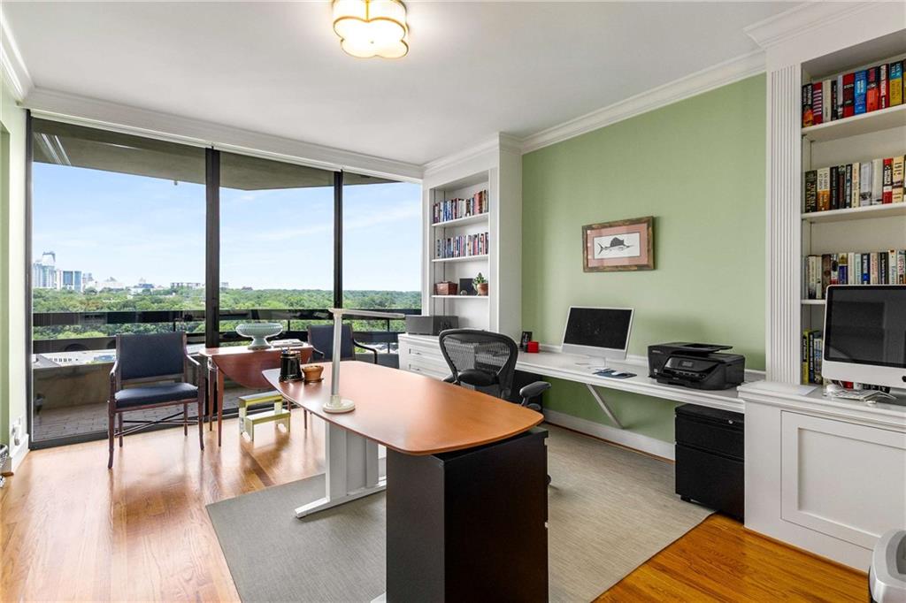 2660 Peachtree Road Northwest, Unit 16F Atlanta, GA 30305 - Photo 13 of 56 a living room with furniture a flat screen tv and a floor to ceiling window