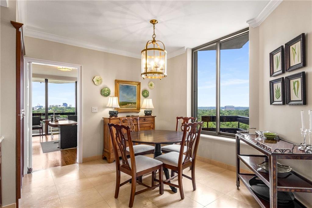 2660 Peachtree Road Northwest, Unit 16F Atlanta, GA 30305 - Photo 16 of 56 a view of a dining room with furniture window and wooden floor