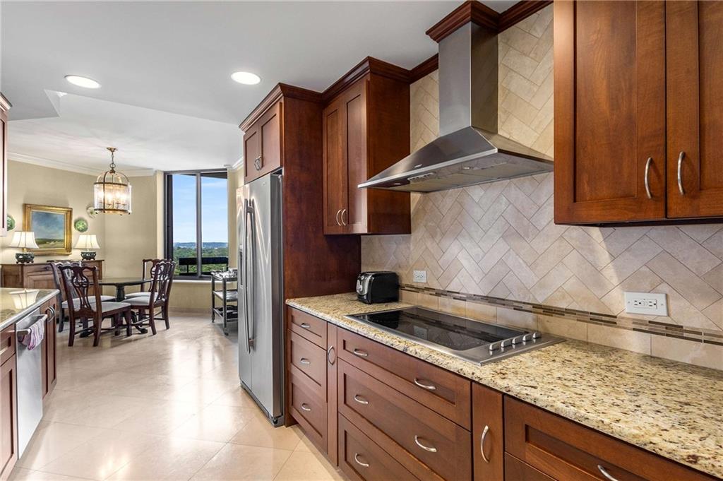 2660 Peachtree Road Northwest, Unit 16F Atlanta, GA 30305 - Photo 23 of 56 a kitchen with stainless steel appliances granite countertop a sink stove and cabinets