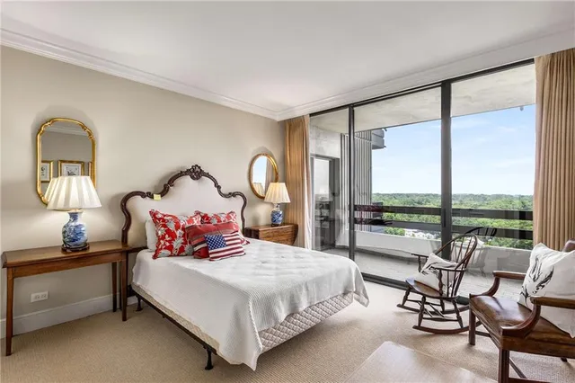 a bedroom with a bed chair and a window