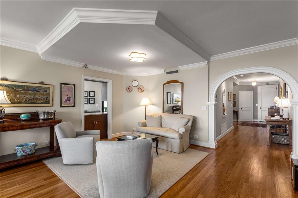2660 Peachtree Road Northwest, Unit 16F Atlanta, GA 30305 - Photo 7 of 56 a living room with furniture and wooden floor
