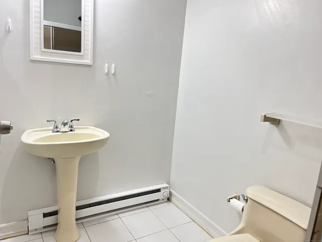 a bathroom with a sink a mirror and a toilet