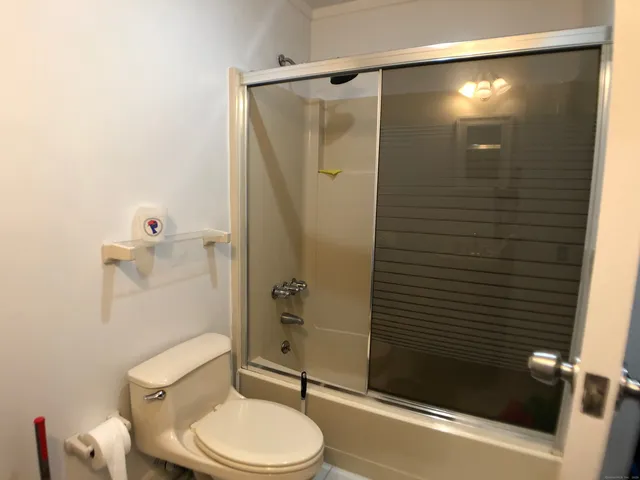 a bathroom with a toilet and shower