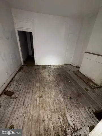 a view of an empty room and wooden floor