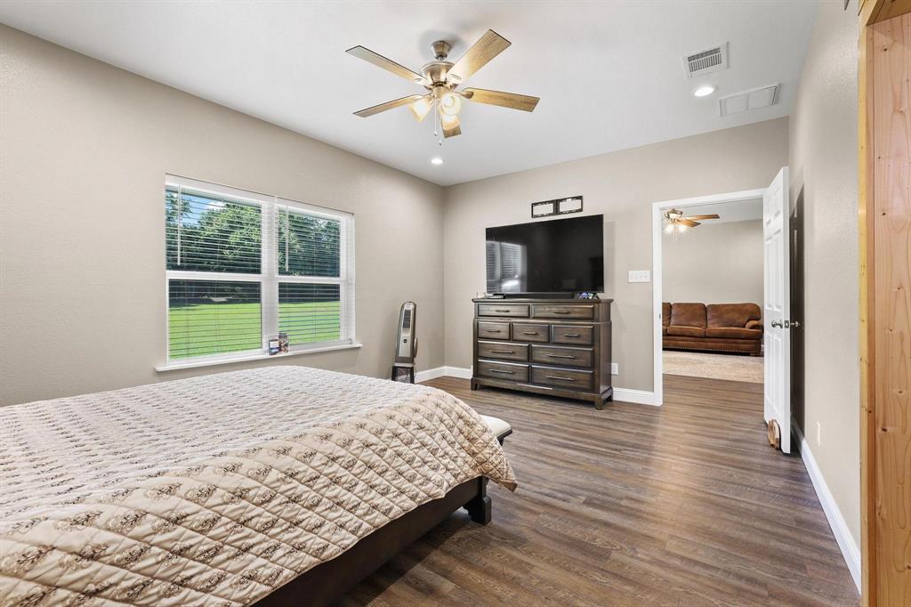 2658 Oak Ridge Road Denison, TX 75021 - Photo 17 of 37 a bedroom with furniture and a flat screen tv