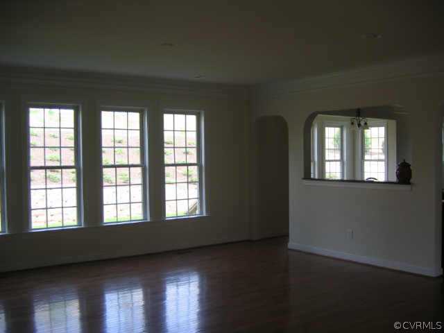 1213 Gravatt Way Midlothian, VA 23114 - Photo 5 of 9 a view of an empty room with wooden floor and a window