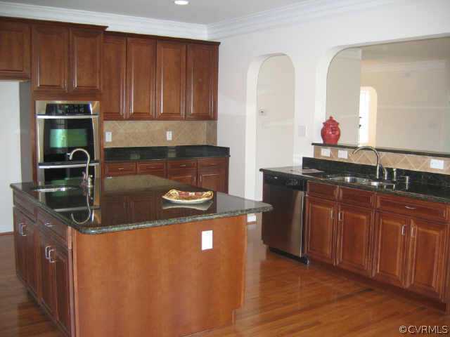 1213 Gravatt Way Midlothian, VA 23114 - Photo 6 of 9 a kitchen with stainless steel appliances granite countertop a stove a sink and a microwave