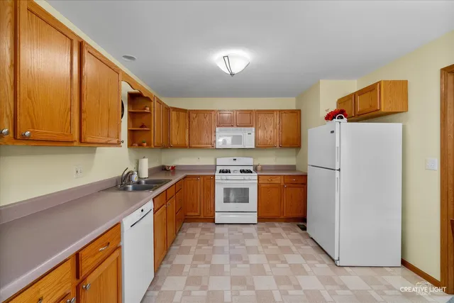 a kitchen with stainless steel appliances granite countertop a refrigerator sink and stove