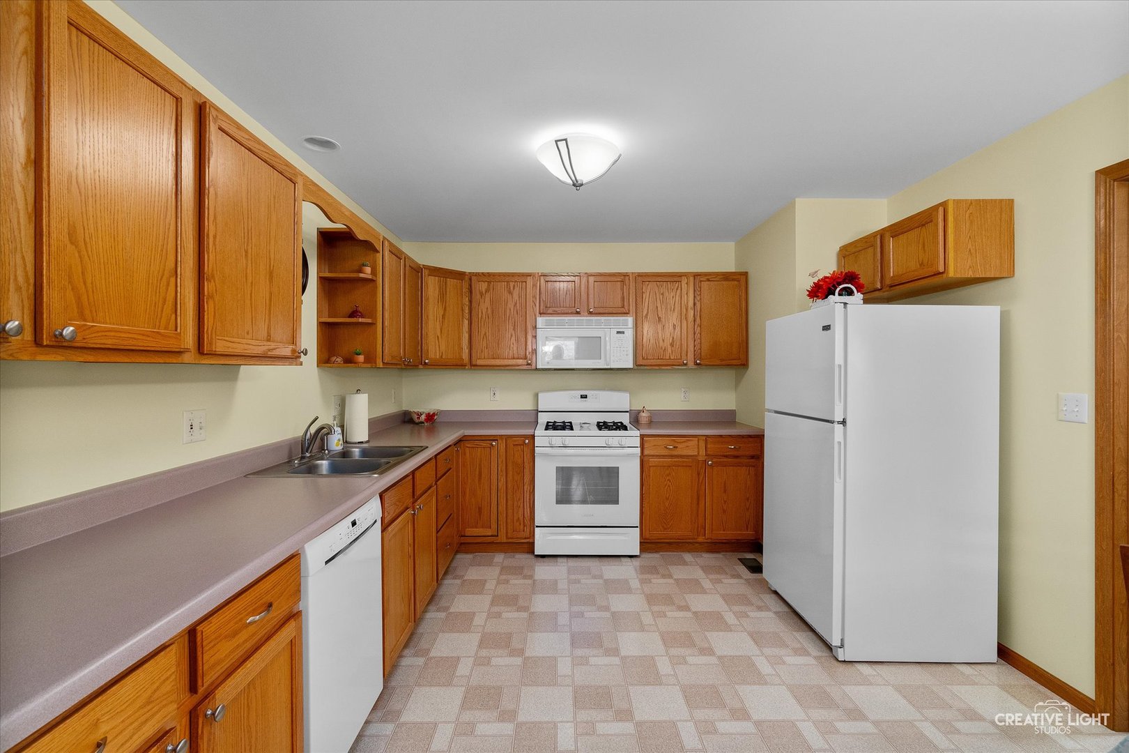 43 Juniper Drive North Aurora, IL 60542 - Photo 5 of 16 a kitchen with stainless steel appliances granite countertop a refrigerator sink and stove