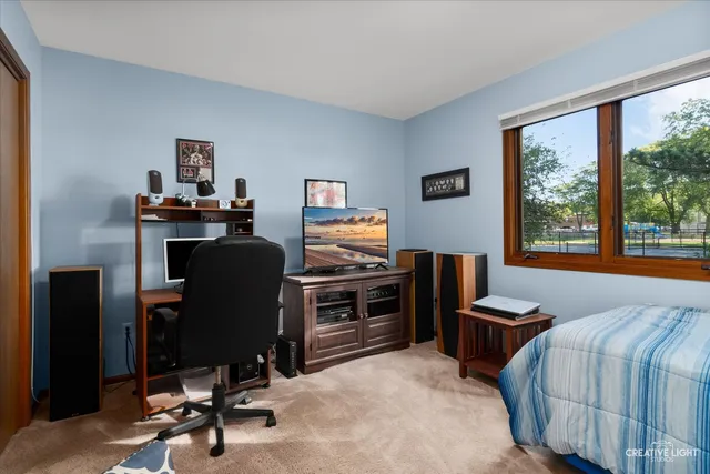 a view of a livingroom with workspace and windows
