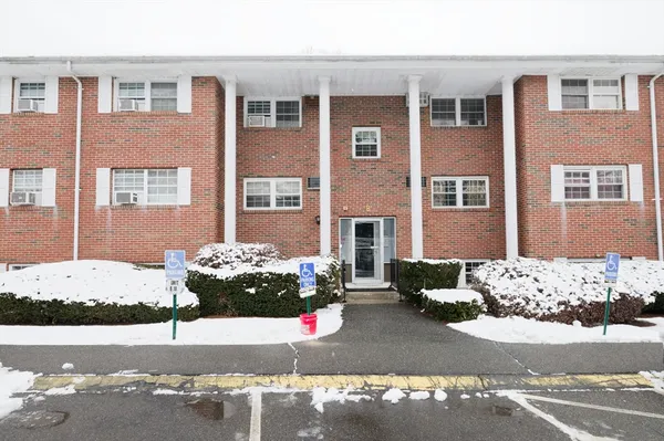 a front view of a house with a road