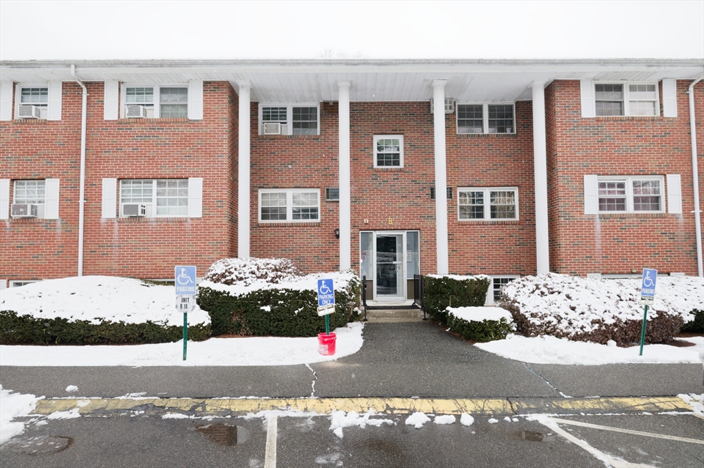 a front view of a house with a road