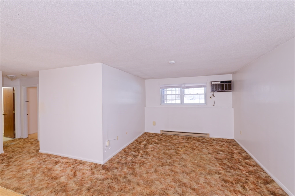 39 Pleasant Street, Unit B4 Northborough, MA 01532 - Photo 4 of 24 an empty room with a natural light