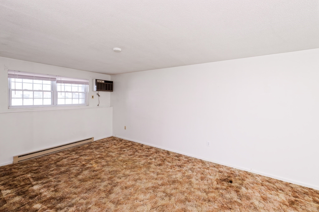 39 Pleasant Street, Unit B4 Northborough, MA 01532 - Photo 5 of 24 an empty room with windows