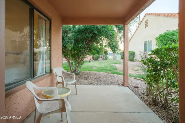 a backyard of a house with table and chairs