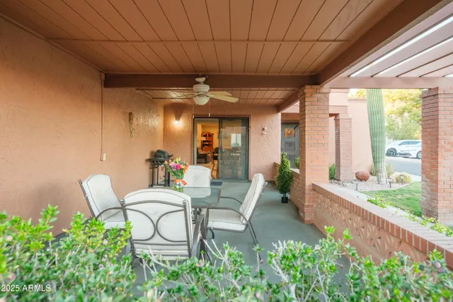 a view of a patio with table and chairs and potted plants