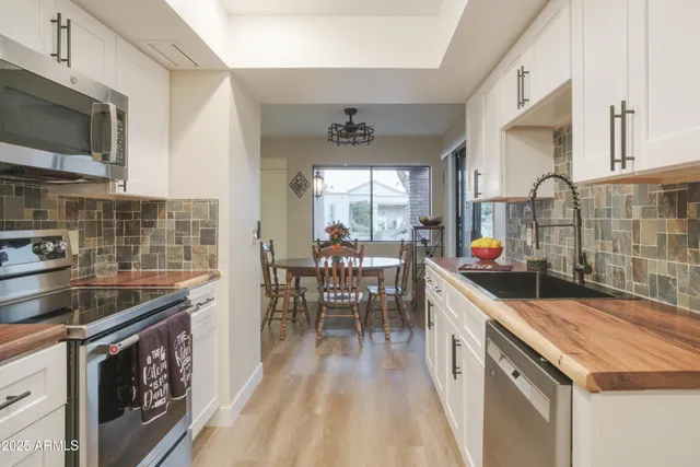 a kitchen with stainless steel appliances granite countertop a stove and cabinets