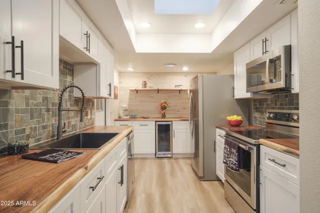 a kitchen with a stove a sink and a refrigerator