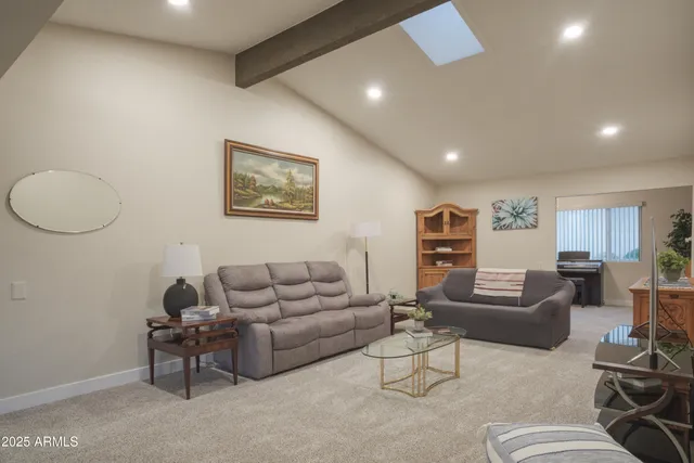 a living room with furniture and a potted plant