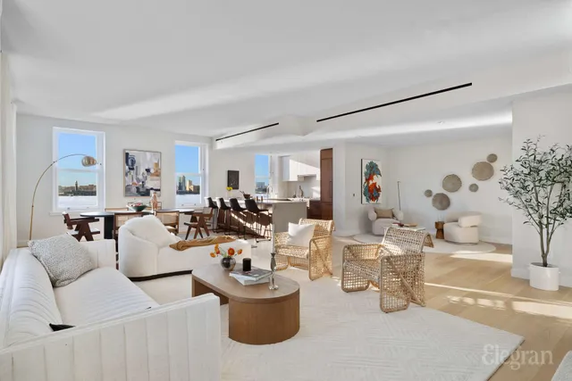 a living room with furniture and large windows